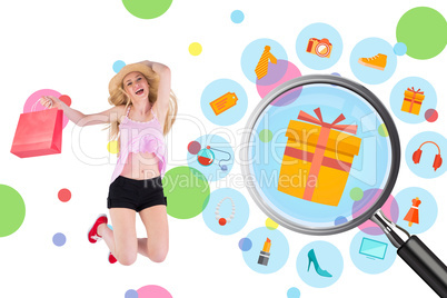 Composite image of pretty young blonde holding shopping bags