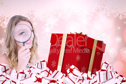 Composite image of smiling woman holding magnifying glass