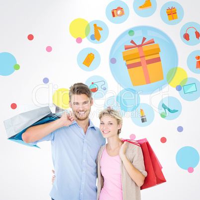 Composite image of attractive young couple holding shopping bags