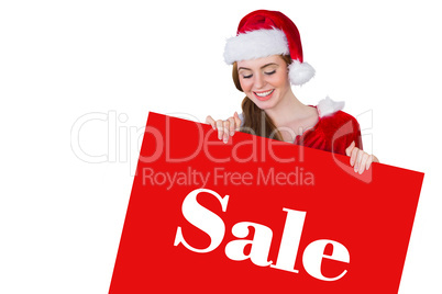 Composite image of pretty girl in santa costume showing card