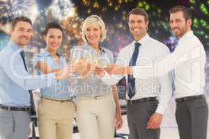 Composite image of business team toasting with champagne in offi