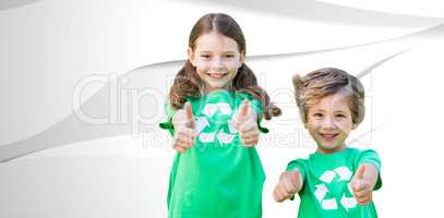Composite image of happy siblings in green with thumbs up