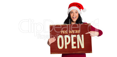 Composite image of woman pointing at white sign