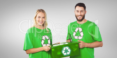 Composite image of portrait of smiling volunteers carrying recyc