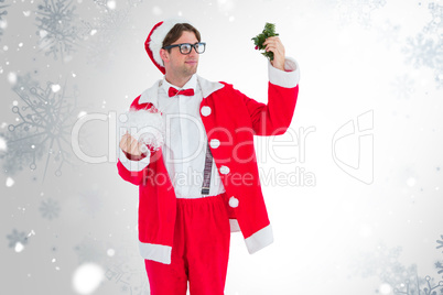 Composite image of geeky hipster in santa costume looking at mis