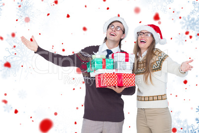 Composite image of smiling man and woman wearing santa hats and