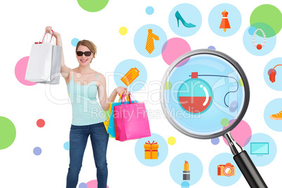 Composite image of woman holding shopping bags wearing sunglasse