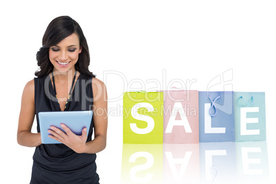 Composite image of smiling elegant brown haired model typing on