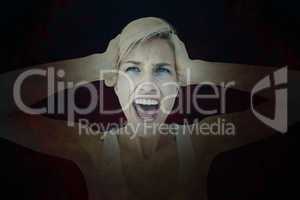 Composite image of angry blonde screaming and holding her head