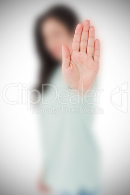 Composite image of beautiful serious woman showing her hand
