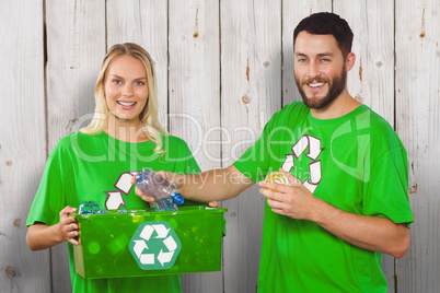 Composite image of portrait of happy man holding bottle