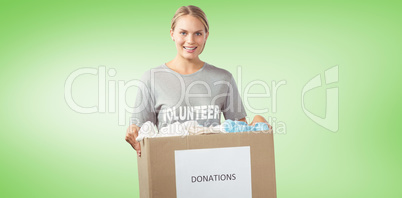 Composite image of portrait of beautiful woman holding clothes d