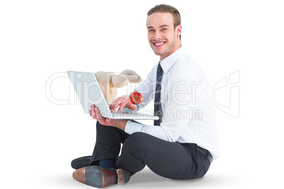 Composite image of santas hand is holding a christmas bulb