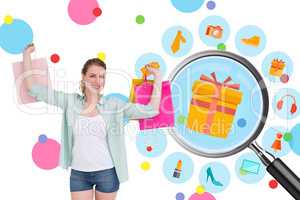 Composite image of smiling young woman holding up shopping bags