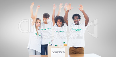 Composite image of volunteers raising their arms