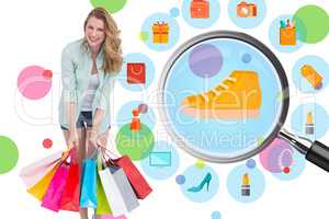 Composite image of smiling woman standing with many shopping bag