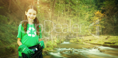 Composite image of happy little girl collecting rubbish