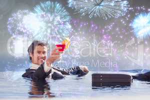 Composite image of cheerful businessman relaxing in a swimming p