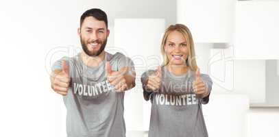 Composite image of smiling volunteers giving thumbs up