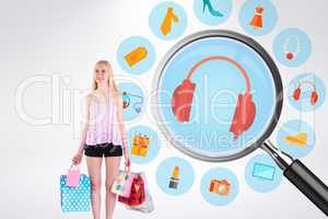 Composite image of pretty young blonde holding shopping bags