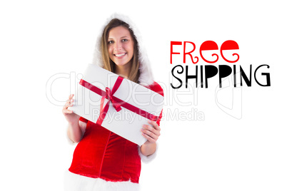 Composite image of pretty santa girl holding gift