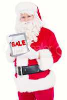 Composite image of happy santa showing digital tablet