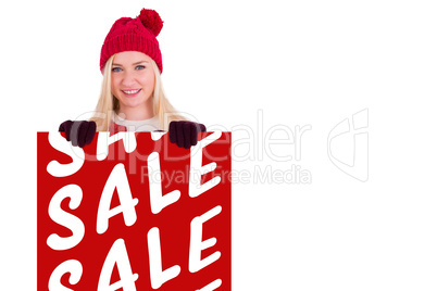 Composite image of festive blonde showing a red poster