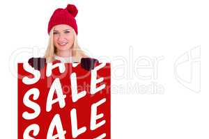 Composite image of festive blonde showing a red poster