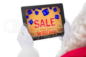 Composite image of santa claus using tablet pc