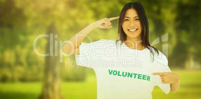 Composite image of smiling woman pointing to her volunteer tshir