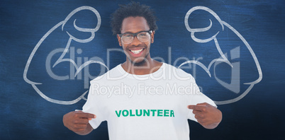 Composite image of handsome man pointing to his volunteer tshirt