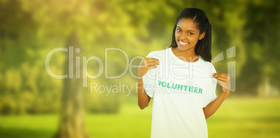 Composite image of young woman wearing volunteer tshirt and poin
