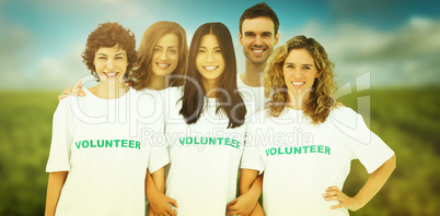 Composite image of group of people wearing volunteer tshirt