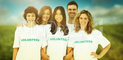 Composite image of group of people wearing volunteer tshirt