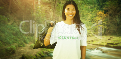 Composite image of team of volunteers picking up litter in park