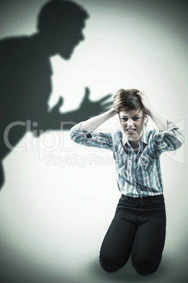 Composite image of pretty brunette getting a headache with hands