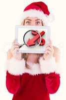 Composite image of pretty santa girl holding tablet