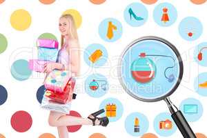 Composite image of pretty young blonde holding shopping bags and