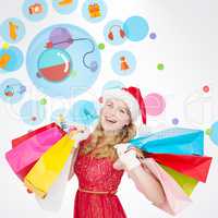 Composite image of excited blonde in santa hat holding shopping