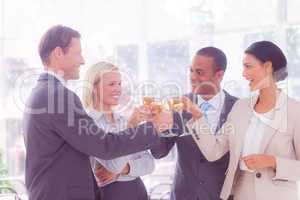 Composite image of business team celebrating with champagne and