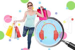 Composite image of happy blonde holding shopping bags