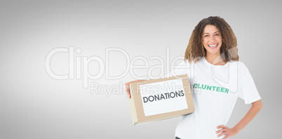 Composite image of smiling volunteer holding a box of donations