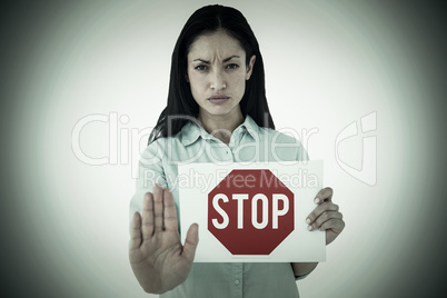 Composite image of woman showing card and saying stop