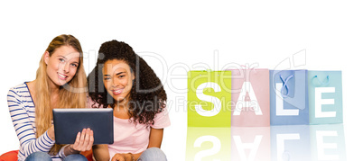 Composite image of portrait of happy female college friends usin