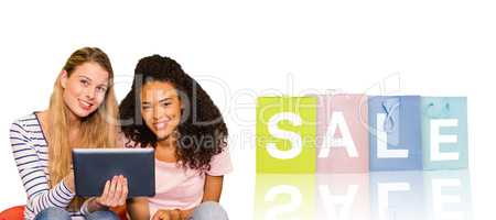 Composite image of portrait of happy female college friends usin