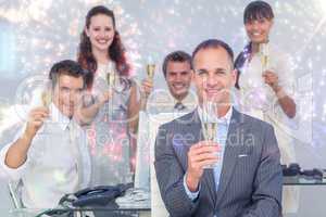 Composite image of successful business coworkers toasting with c