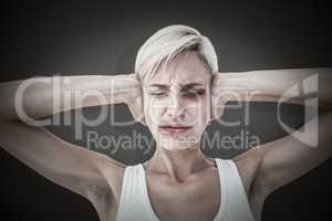 Composite image of upset woman covering her ears