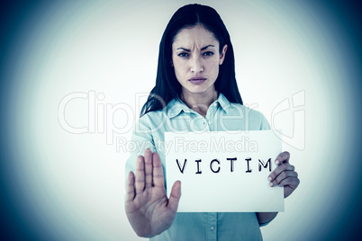 Composite image of woman showing card and saying stop