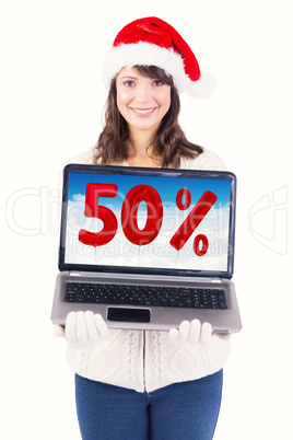 Composite image of smiling brunette in santa hat showing her lap