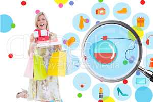 Composite image of elegant blonde with shopping bags and gifts